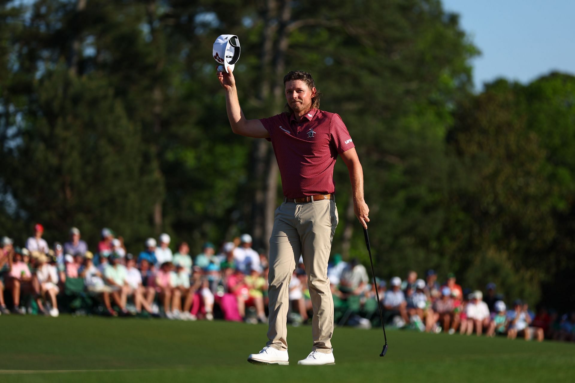 Cameron Smith waves his hat to the crowd on the 18th green during the final round of the 2024 Masters.