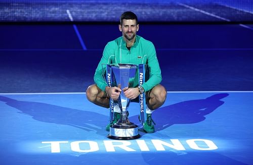 Novak Djokovic posing with the 2023 Nitto ATP Finals trophy