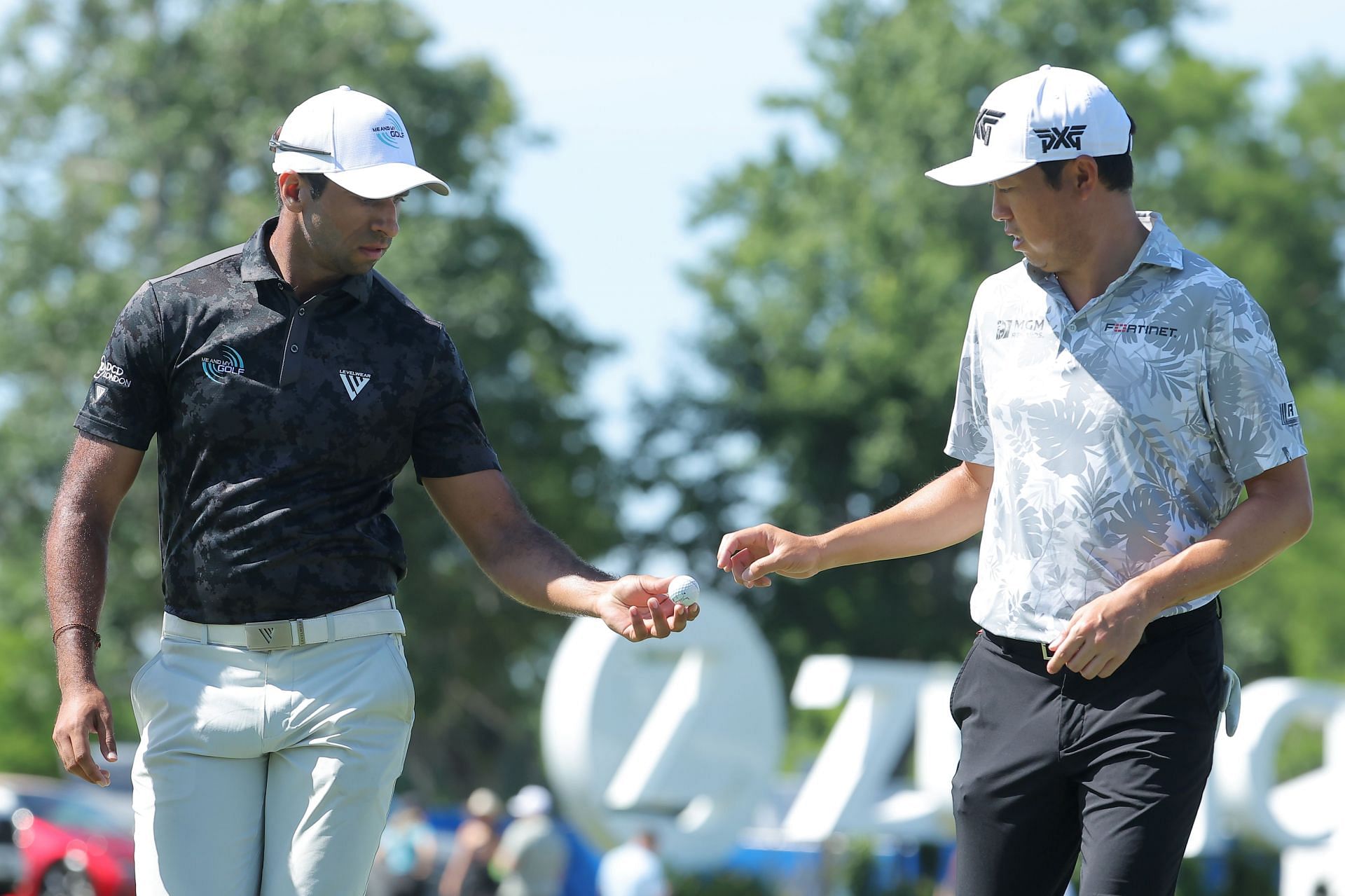 Aaron Rai hands David Lipsky a ball during the second round of the Zurich Classic of New Orleans