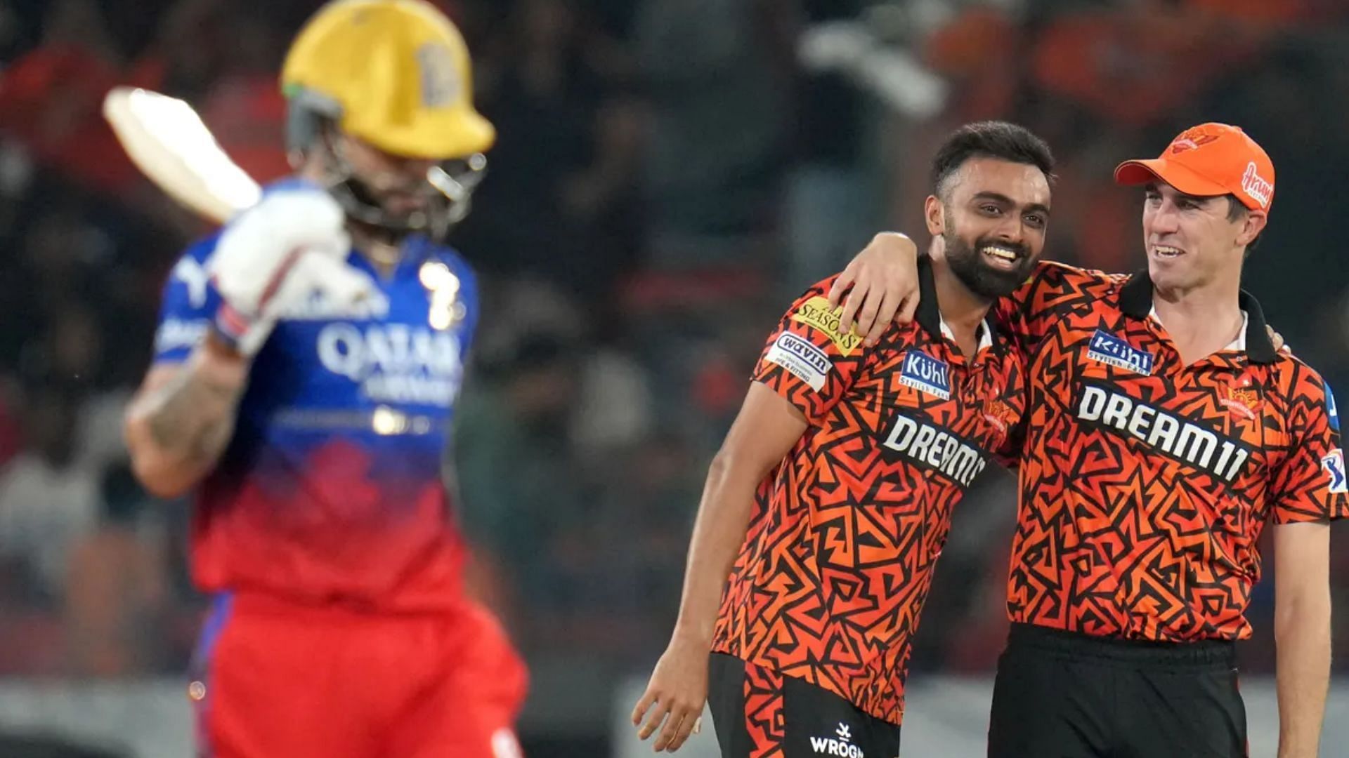 Jaydev Unadkat and Pat Cummins celebrate Virat Kohli