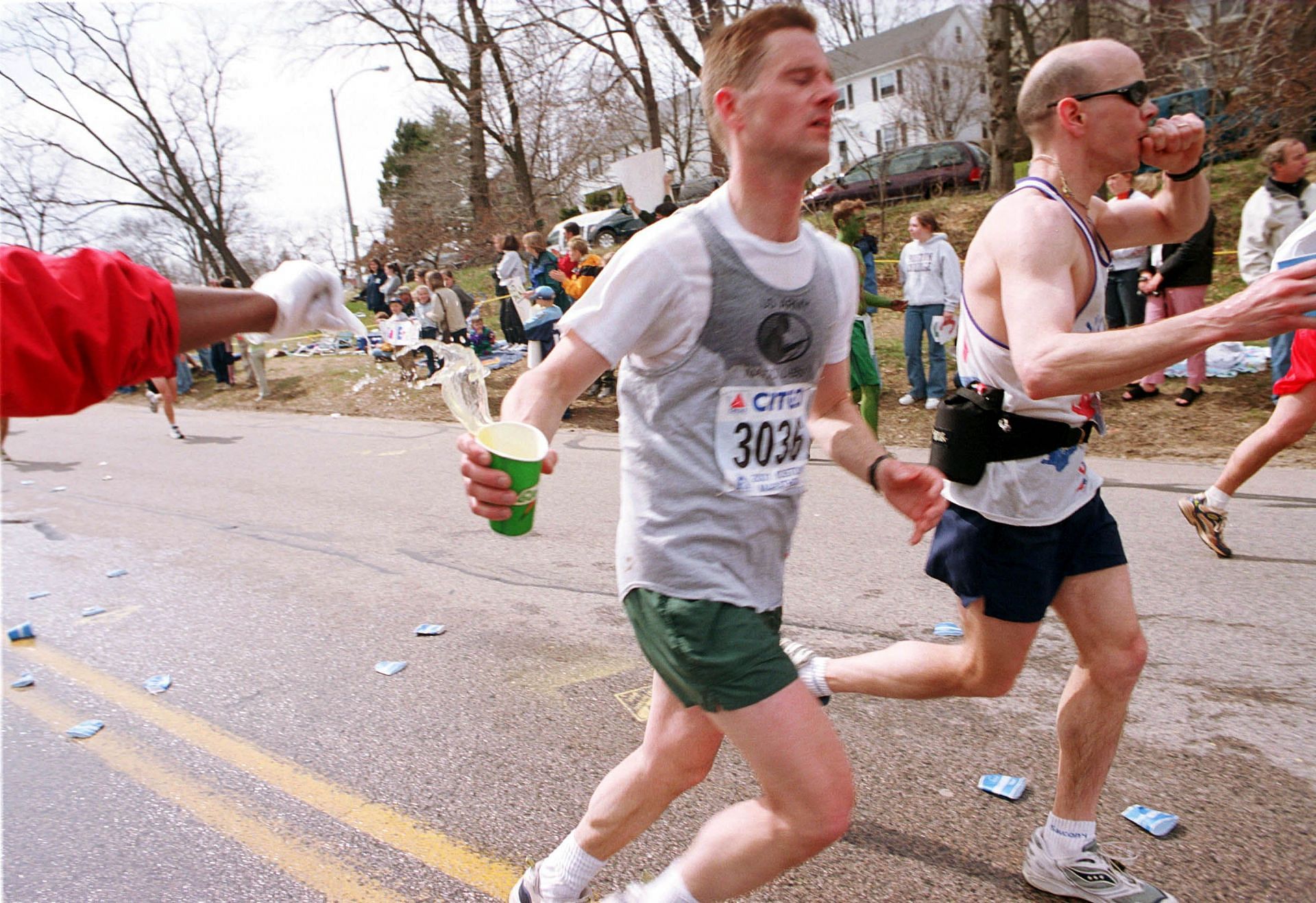 Runners grab cups of water at the top of Heartbreak Hill April 16th, 2001 during the 105th Boston Marathon in Boston MA. (Photo by Darren McCollester/Newsmakers)