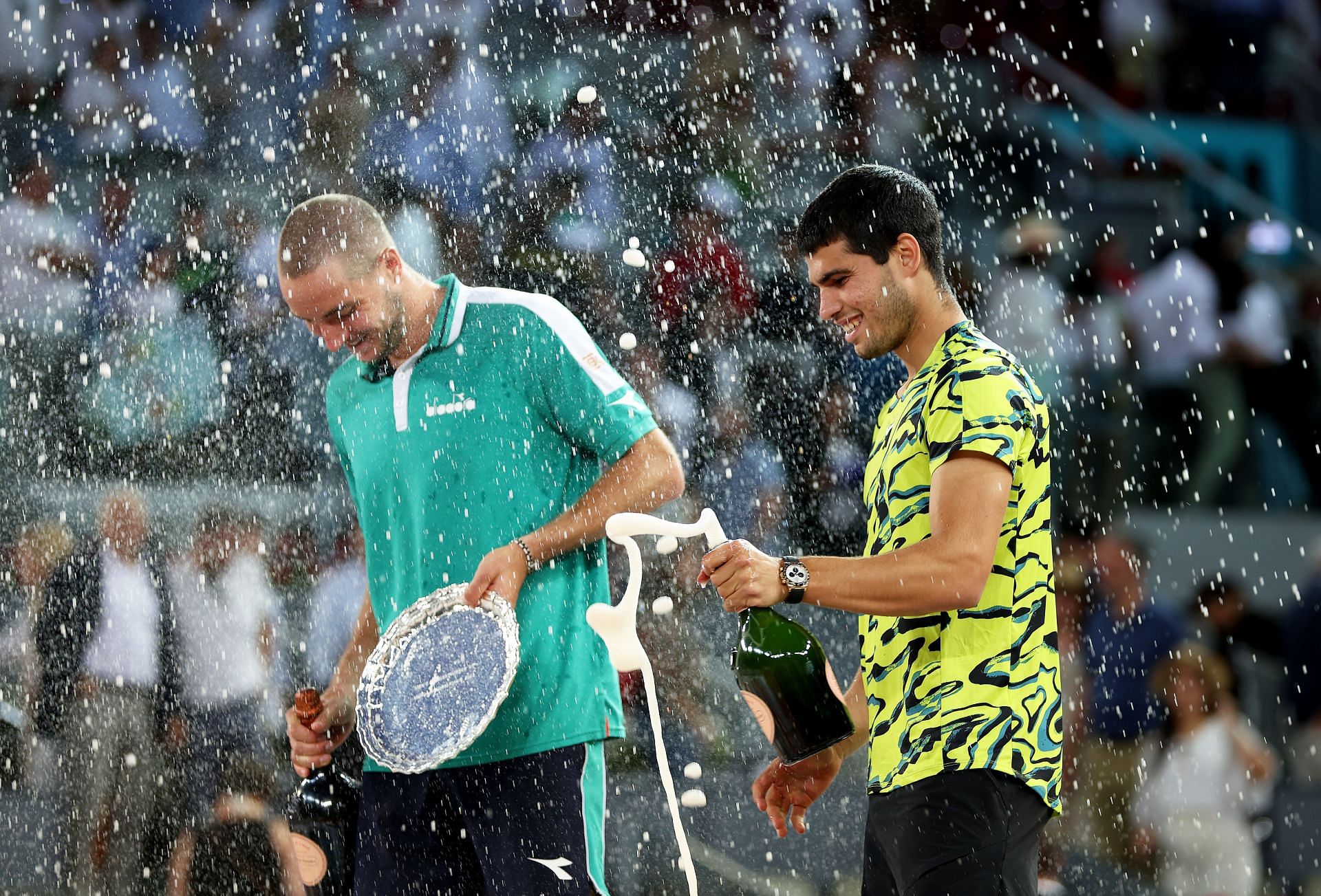 Jan-Lennard Struff (L) and Carlos Alcaraz (R) during the post-match trophy presentation ceremony at the 2023 Mutua Madrid Open
