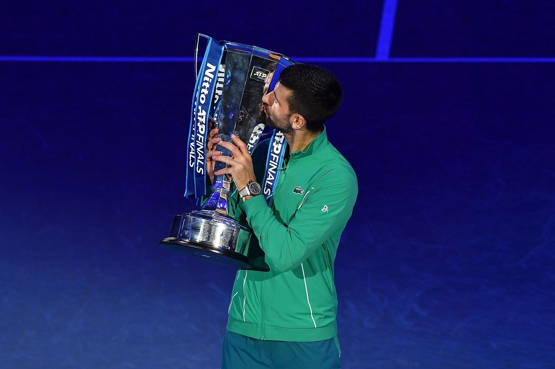 The 24-time Major winner poses with the 2023 Nitto ATP Finals title
