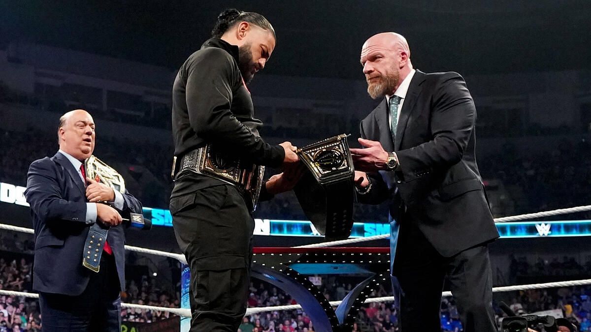 Triple H provides Roman Reigns with the Undisputed WWE Universal Title.