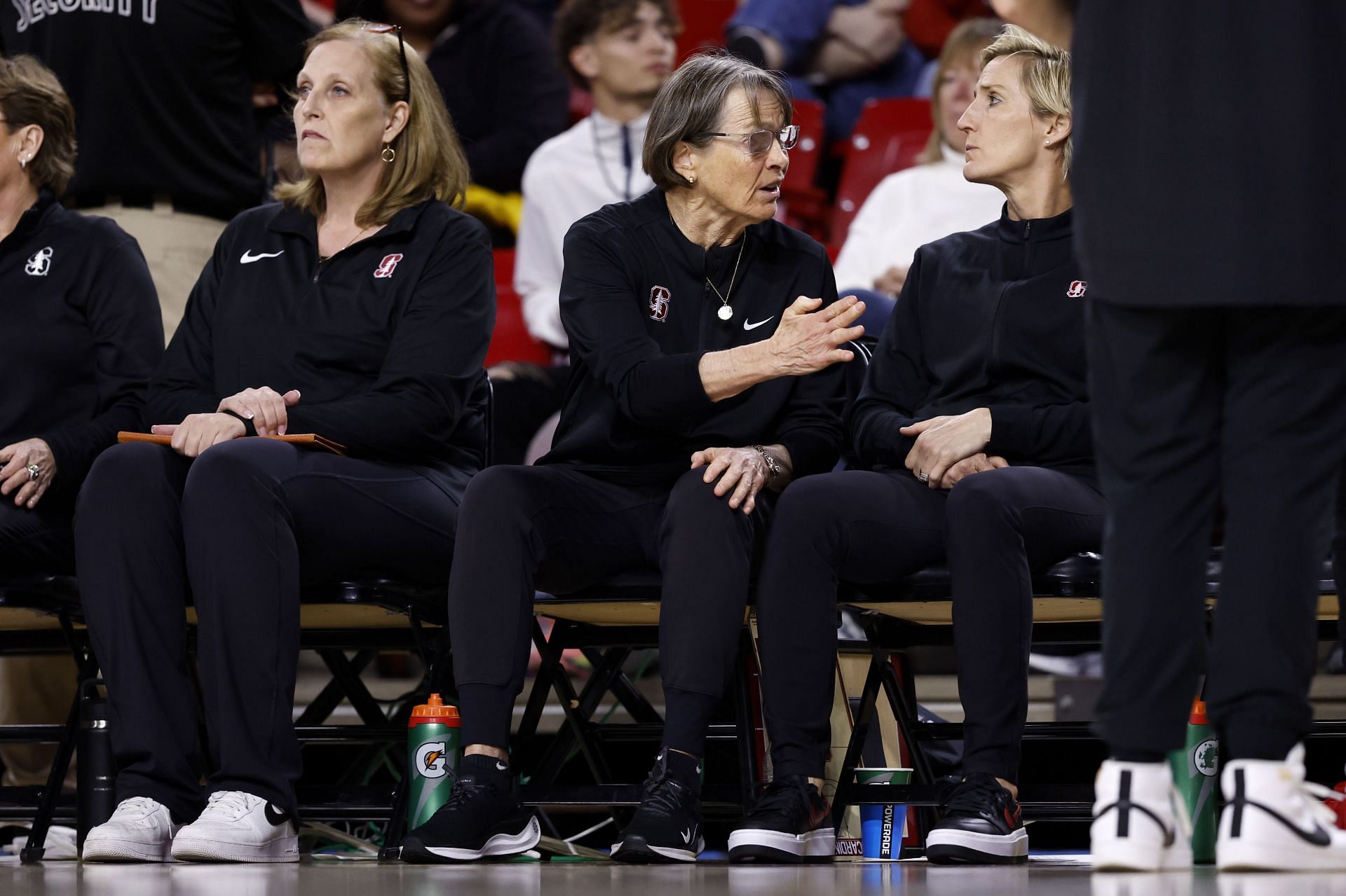 Paye (third from left) looks on as Stanford coach Tara VanDerveer talks about strategies for the team.