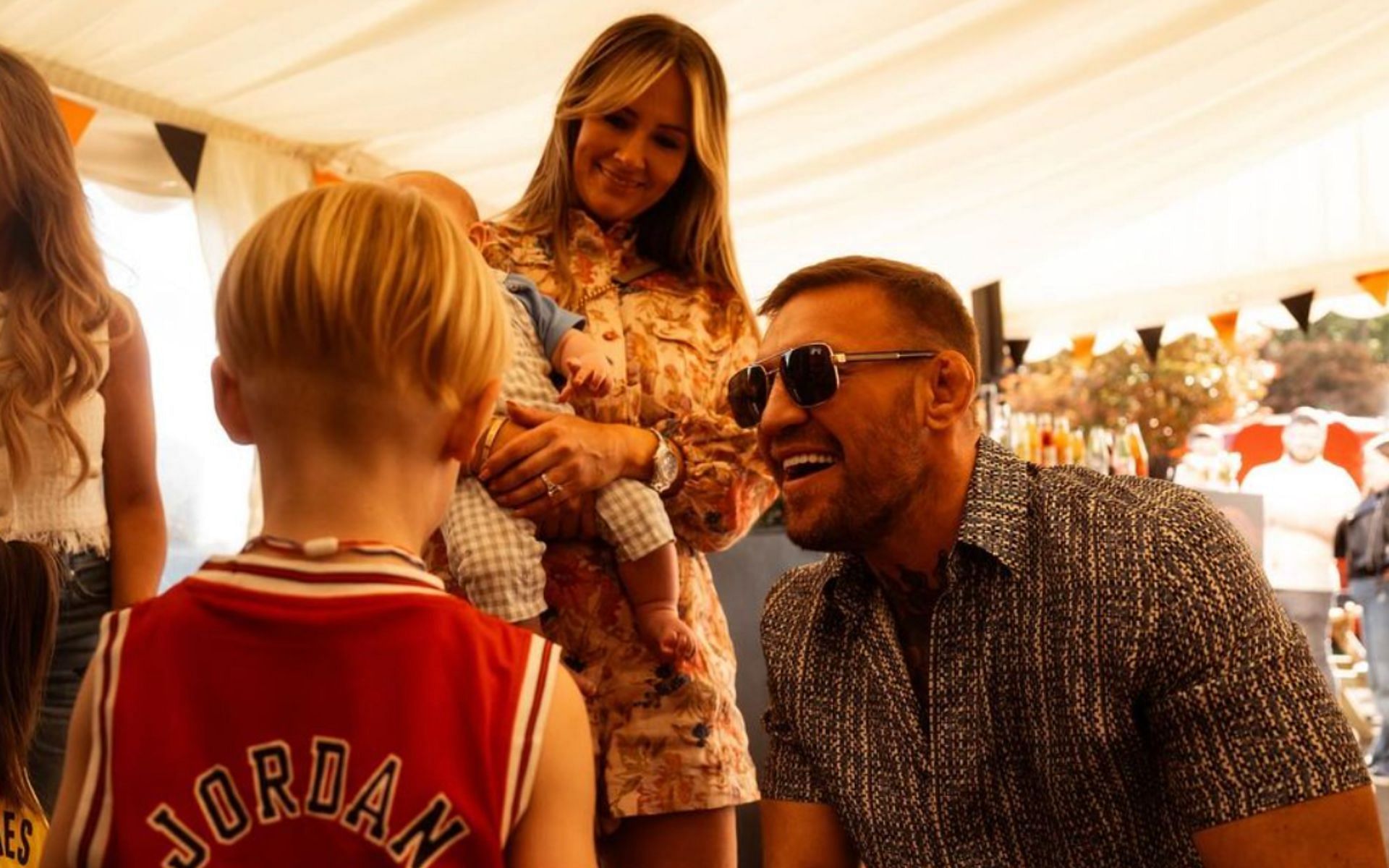 Conor McGregor (right) and Dee Devlin (center) celebrate the seventh birthday of Conor McGregor Jr. (left) on May 5 [Photo Courtesy @thenotoriousmma on Instagram]