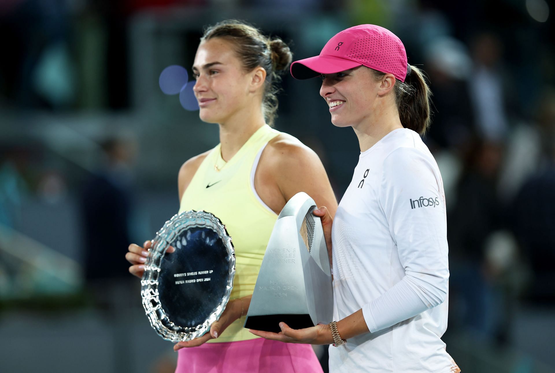 Iga Swiatek and Aryna Sabalenka pose during the trophy ceremony in Madrid