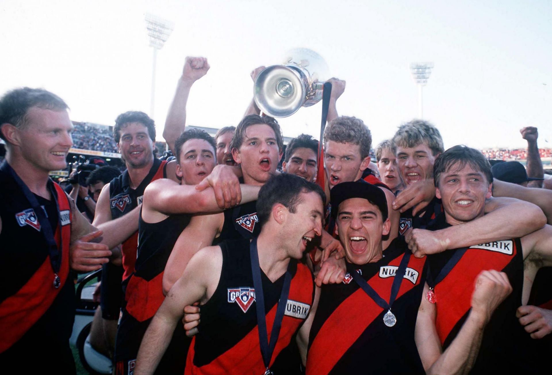 1993: Essendon players celebrate their win with the Premiership Cup, in 1991