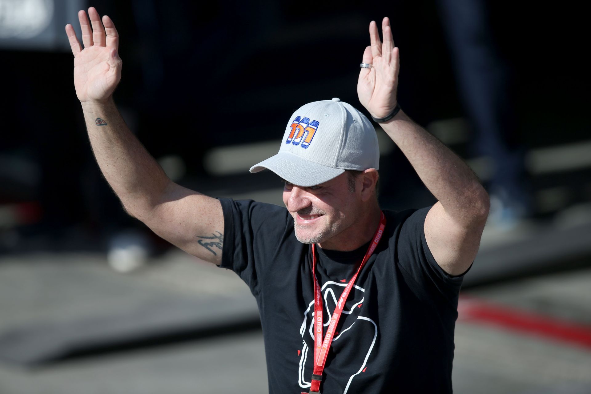 Rubens Barrichello waves to the crowd from parc ferme during qualifying