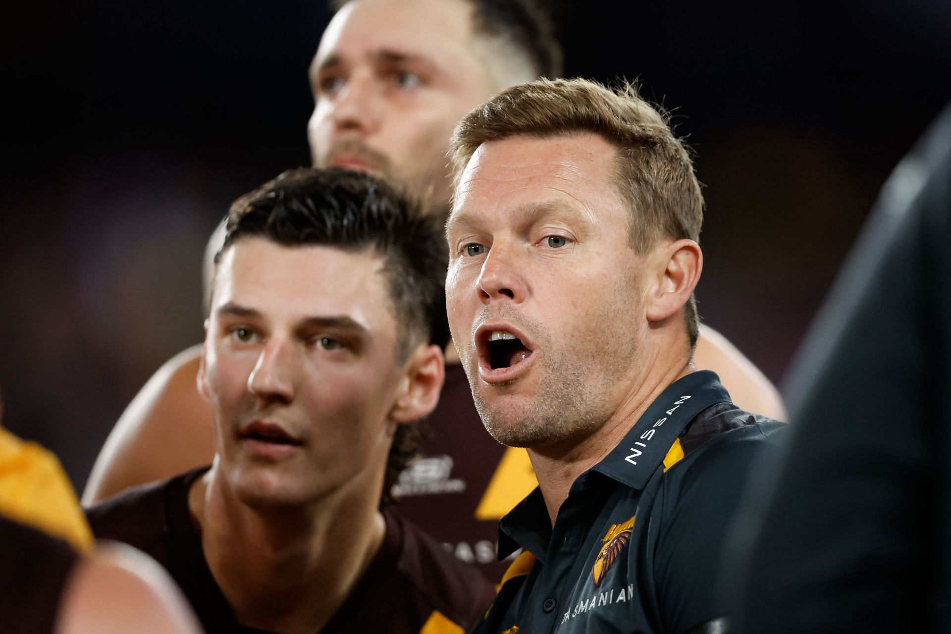 Sam Mitchell, Senior Coach of the Hawks addresses his players at three quarter time during the 2024 AFL Round 08 match between the Western Bulldogs