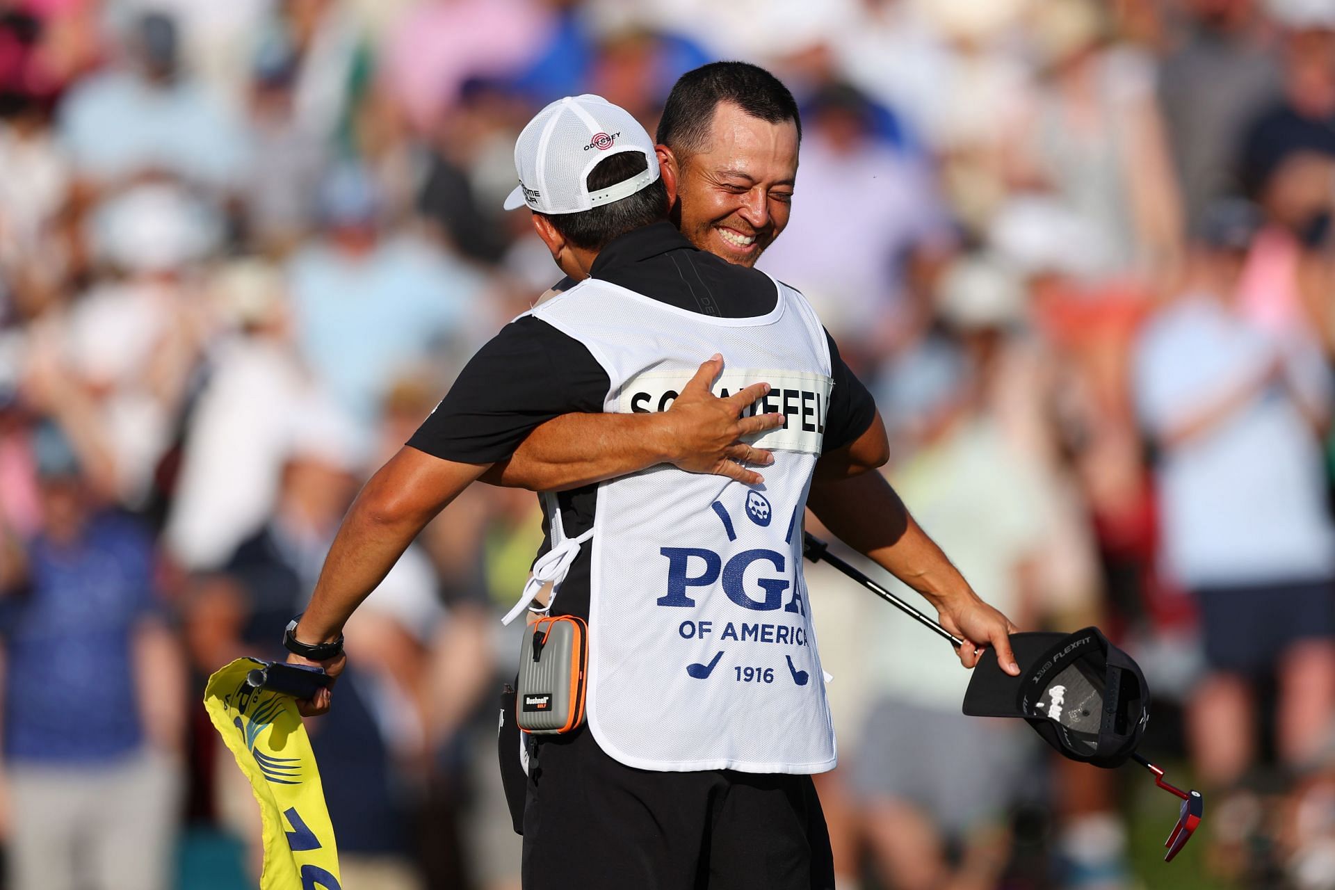 Xander Schauffele and his caddie celebrating the win