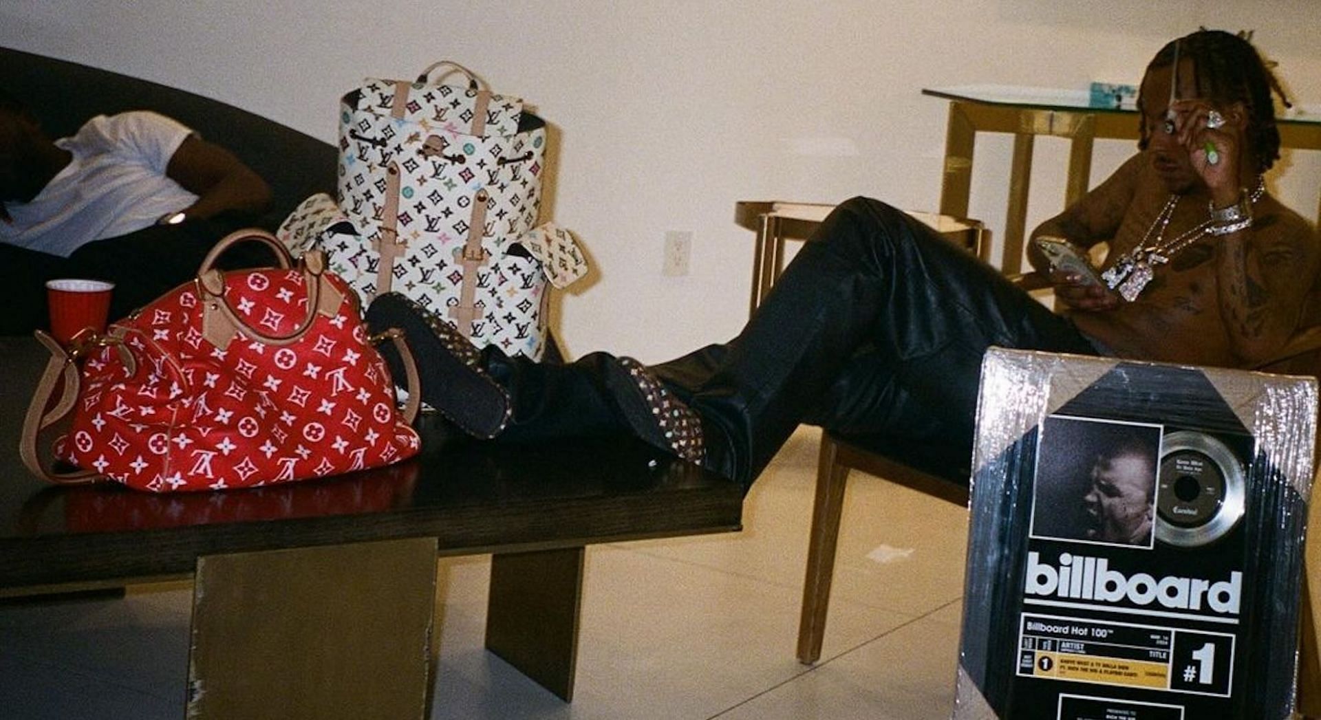 Rich The Kid posing with his No.1 record plaque from Billboard for 