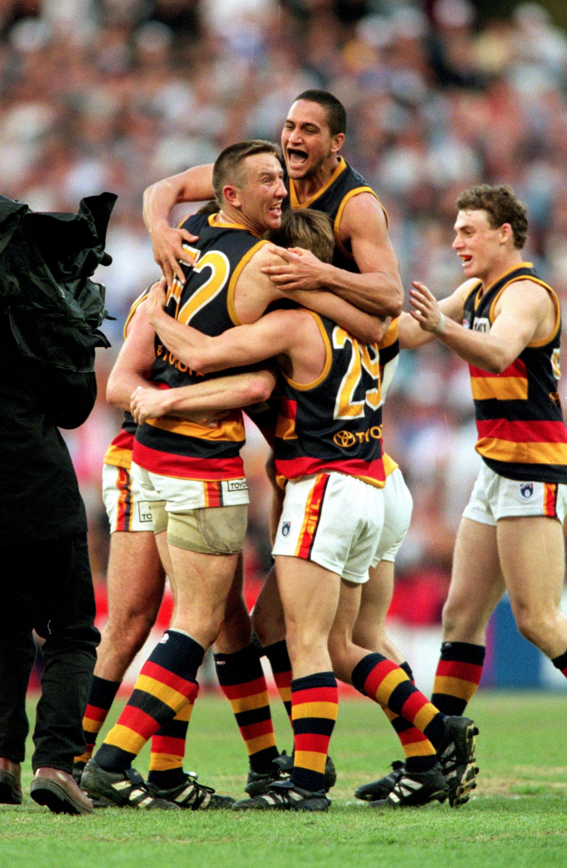 The Adelaide Crows celebrate after winning the 1998 AFL Grand Final between the Adelaide Crows and the North Melbourne Kangaroos
