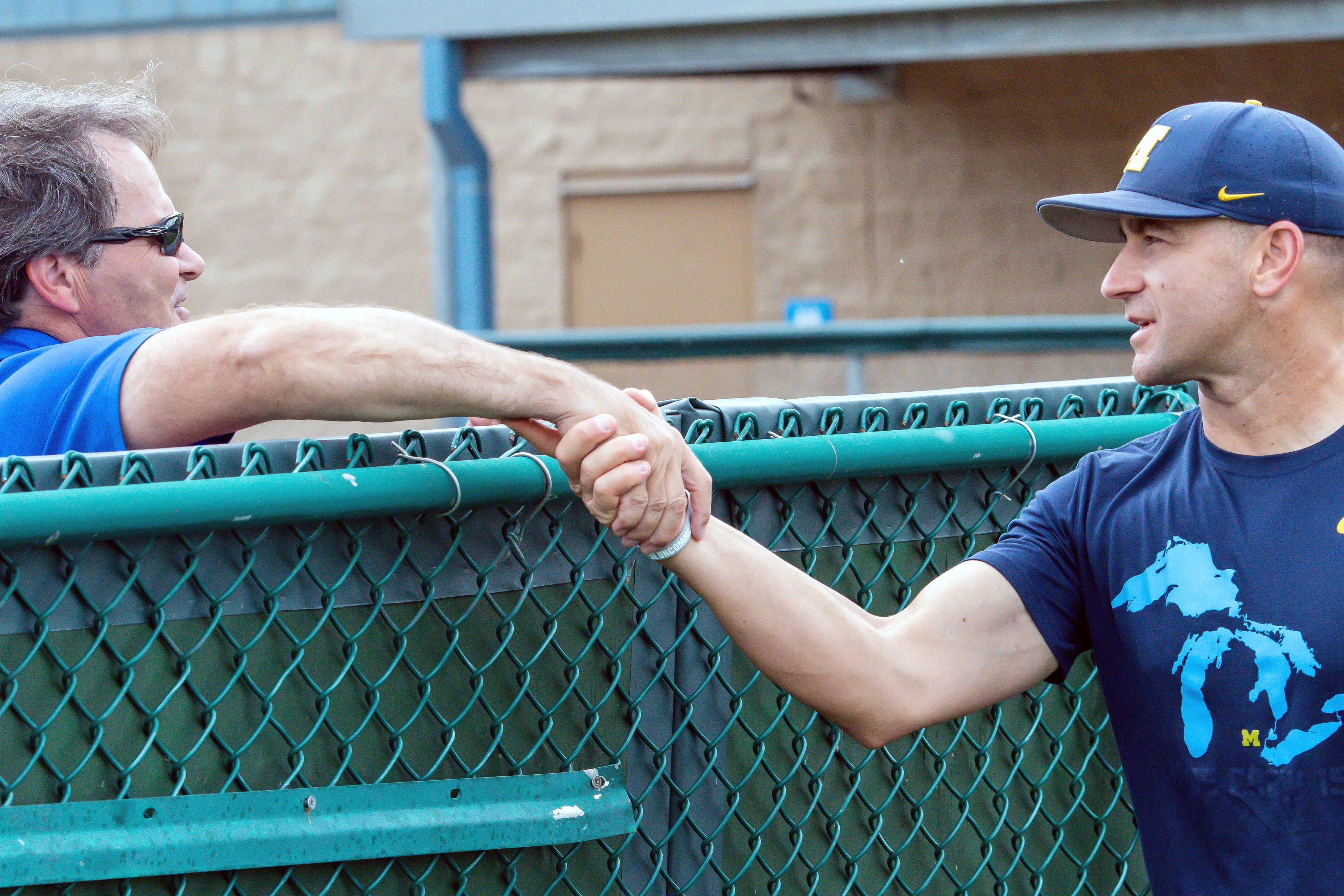 Creighton Bluejays Ed Servais shares a moment with Michigan Wolverines Head Coach Erik Bakich.