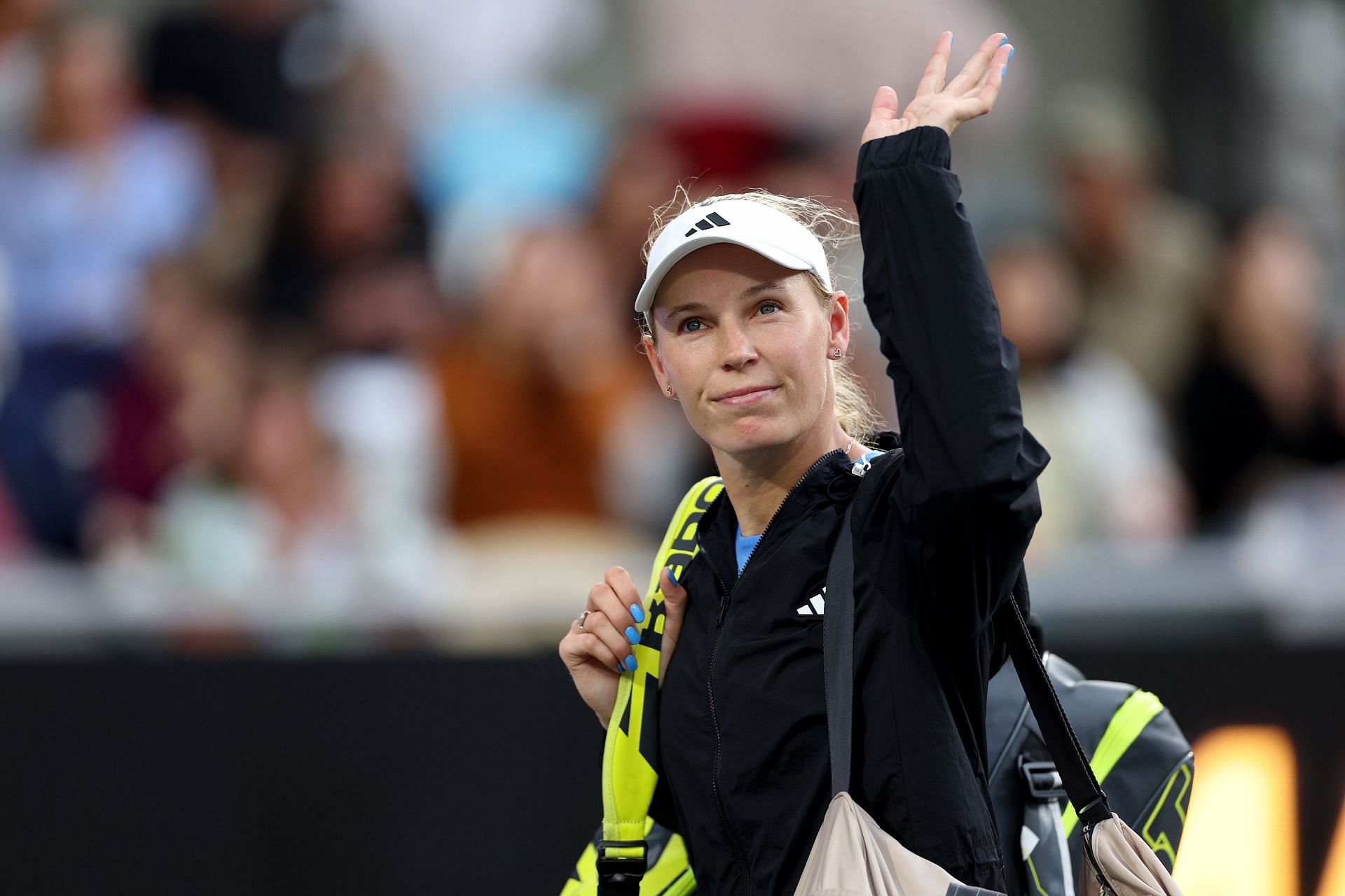 Caroline Wozniacki waves to the crowd at Charleston Open 2024