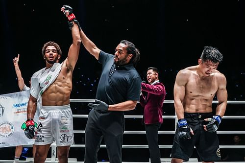 Referee Herb Dean raises Maurice Abevi's hand after his win over Zhang Lipeng.