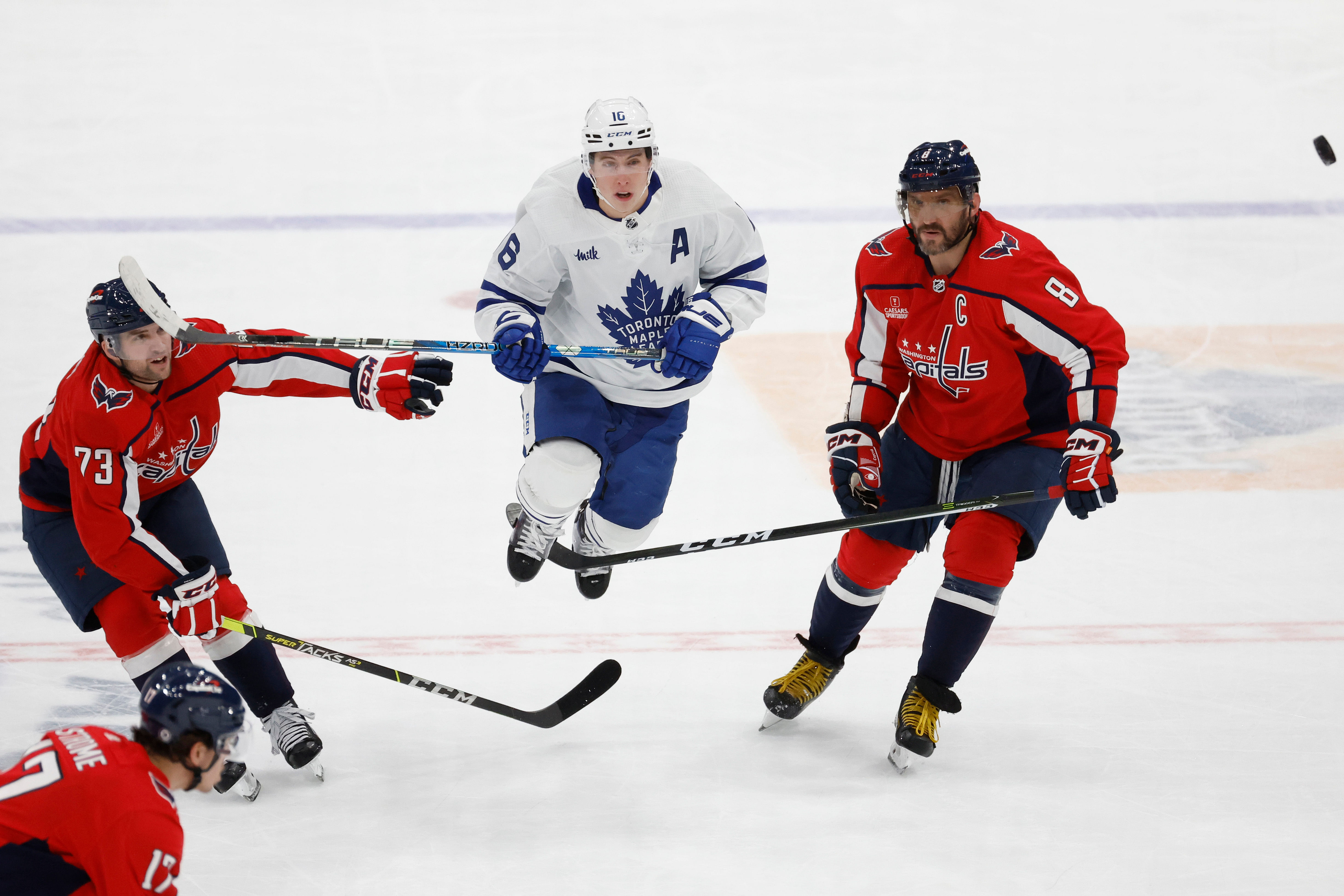 Mitch Marner and Alex Ovechkin battle against one another.