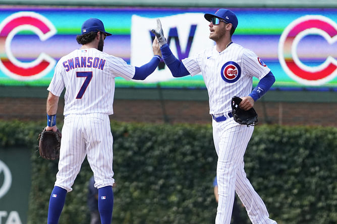 PHOTO: Cody Bellinger's partner Chase Carter and Dansby Swanson's wife Mallory Swanson cheer on their husbands at Cubs game