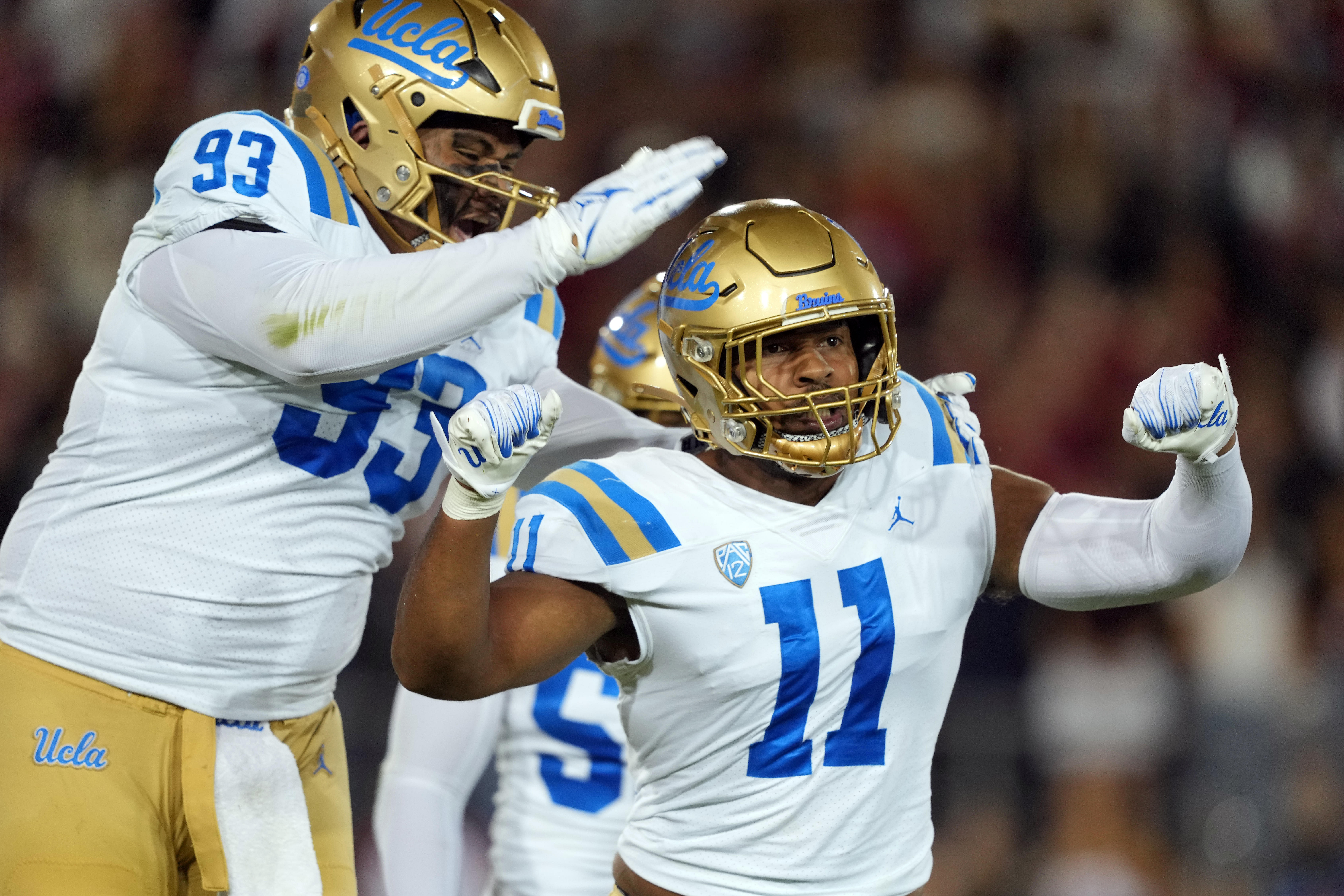 UCLA Bruins defensive lineman Gabriel Murphy (11) celebrates with defensive lineman Jay Toia (93) after recording a sack against the Stanford Cardinal