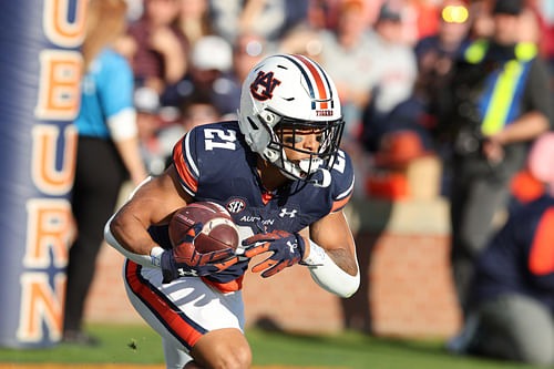 NCAA Football: Alabama at Auburn: Nov 25, 2023; Auburn, Alabama, USA; Auburn Tigers running back Brian Battie (21) returns a kick during the first quarter against the Alabama Crimson Tide at Jordan-Hare Stadium. Mandatory Credit: John Reed-USA TODAY Sports