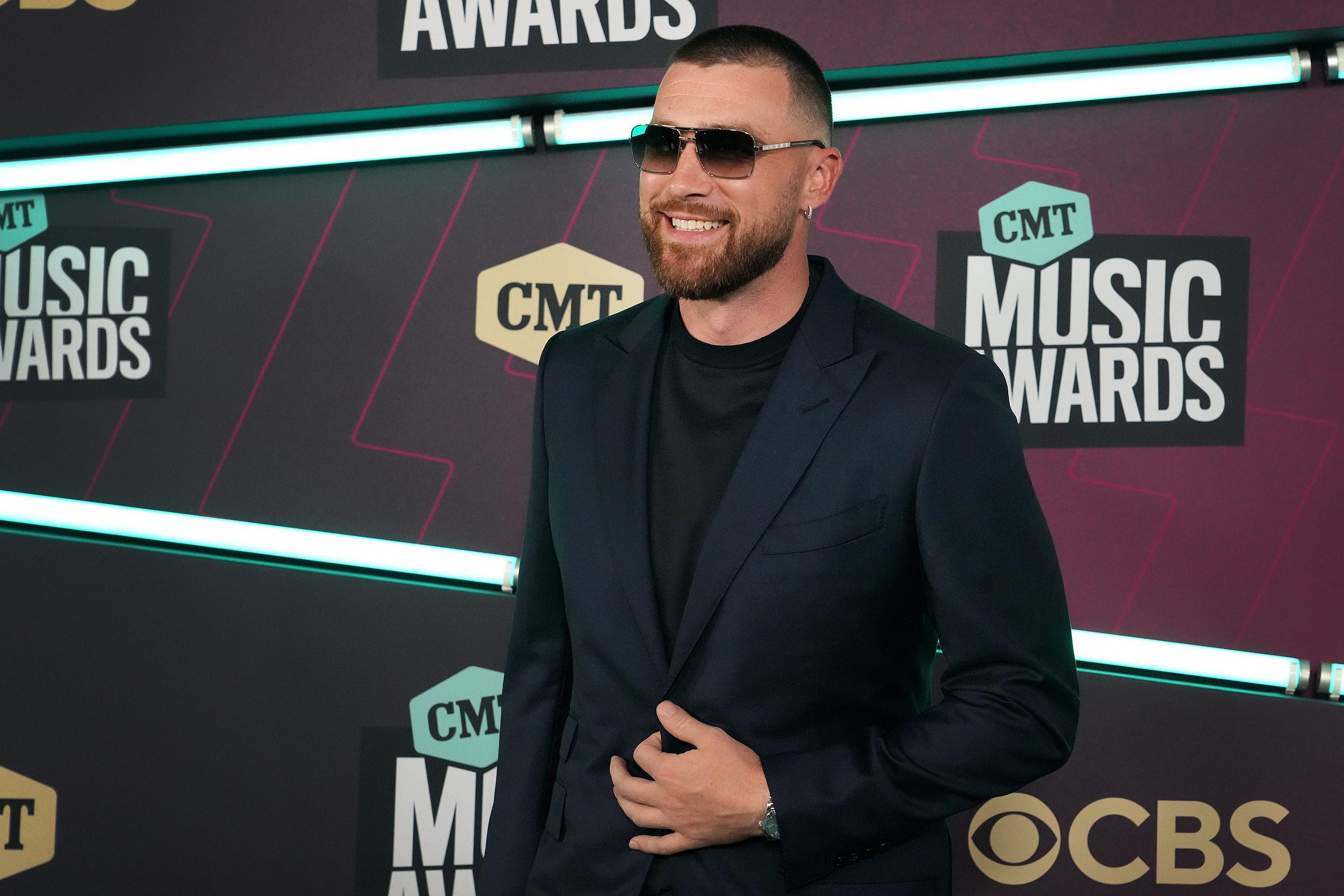 Travis Kelce smiles for the camera at CMT Music Awards