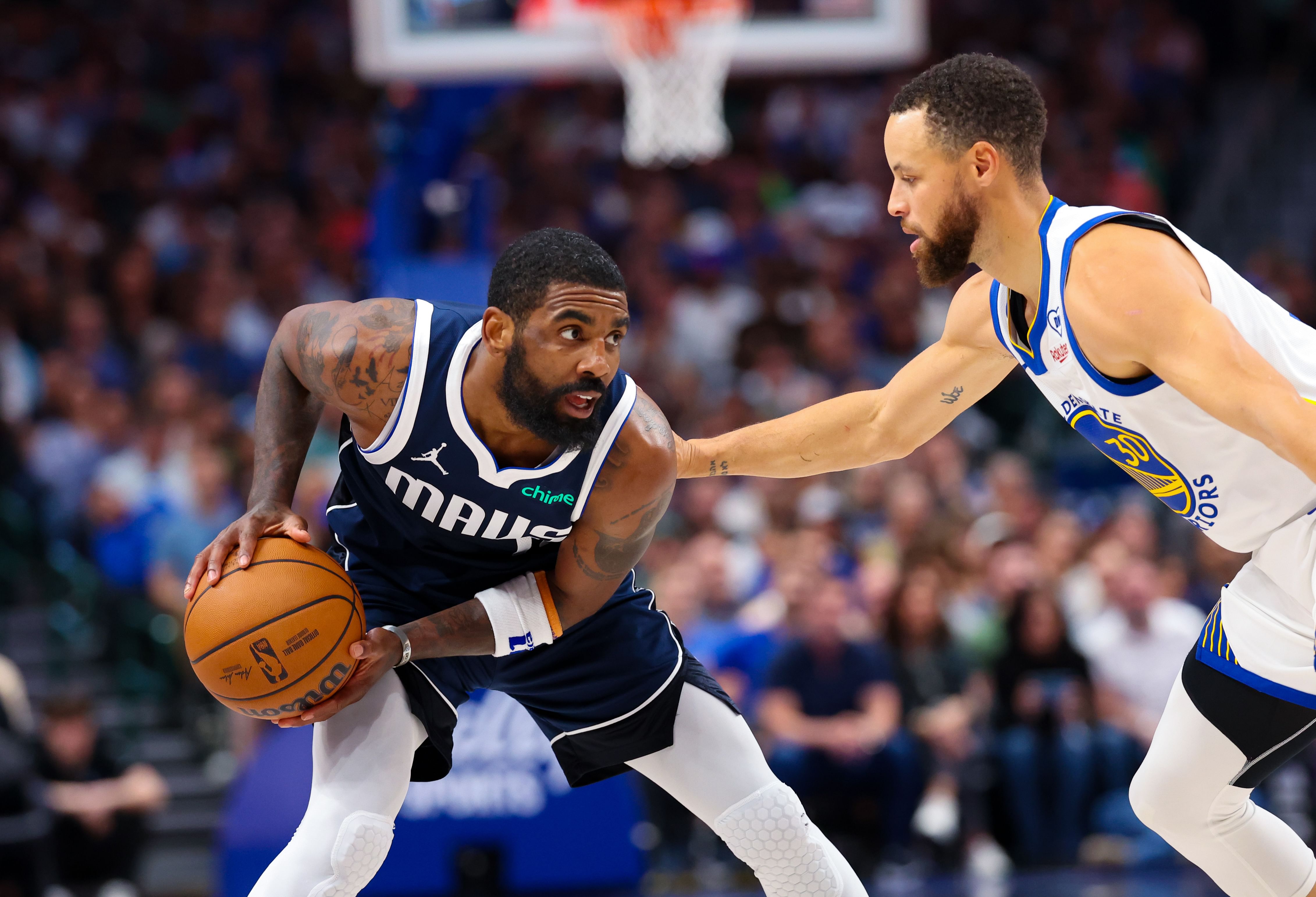 Golden State Warriors&#039; Steph Curry guarding Dallas Mavericks&#039; Kyrie Irving