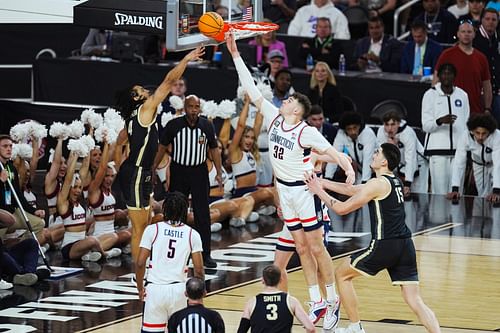 Donovan Clingan (32) blocks Trey Kaufman Renn's shot in the Final Four of the NCAA Tournament, April 2024