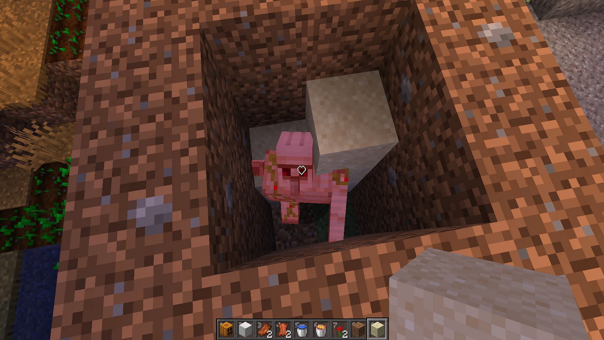 An iron golem suffocating in a pile of sand (Image via Mojang)