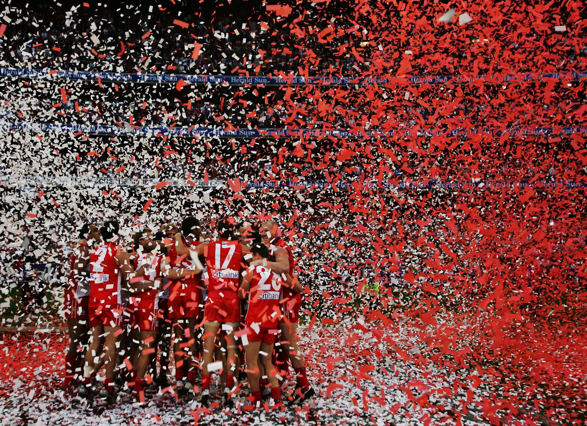 Swans players celebrate victory after the 2005 AFL Grand Final between the Sydney Swans and the West Coast Eagles