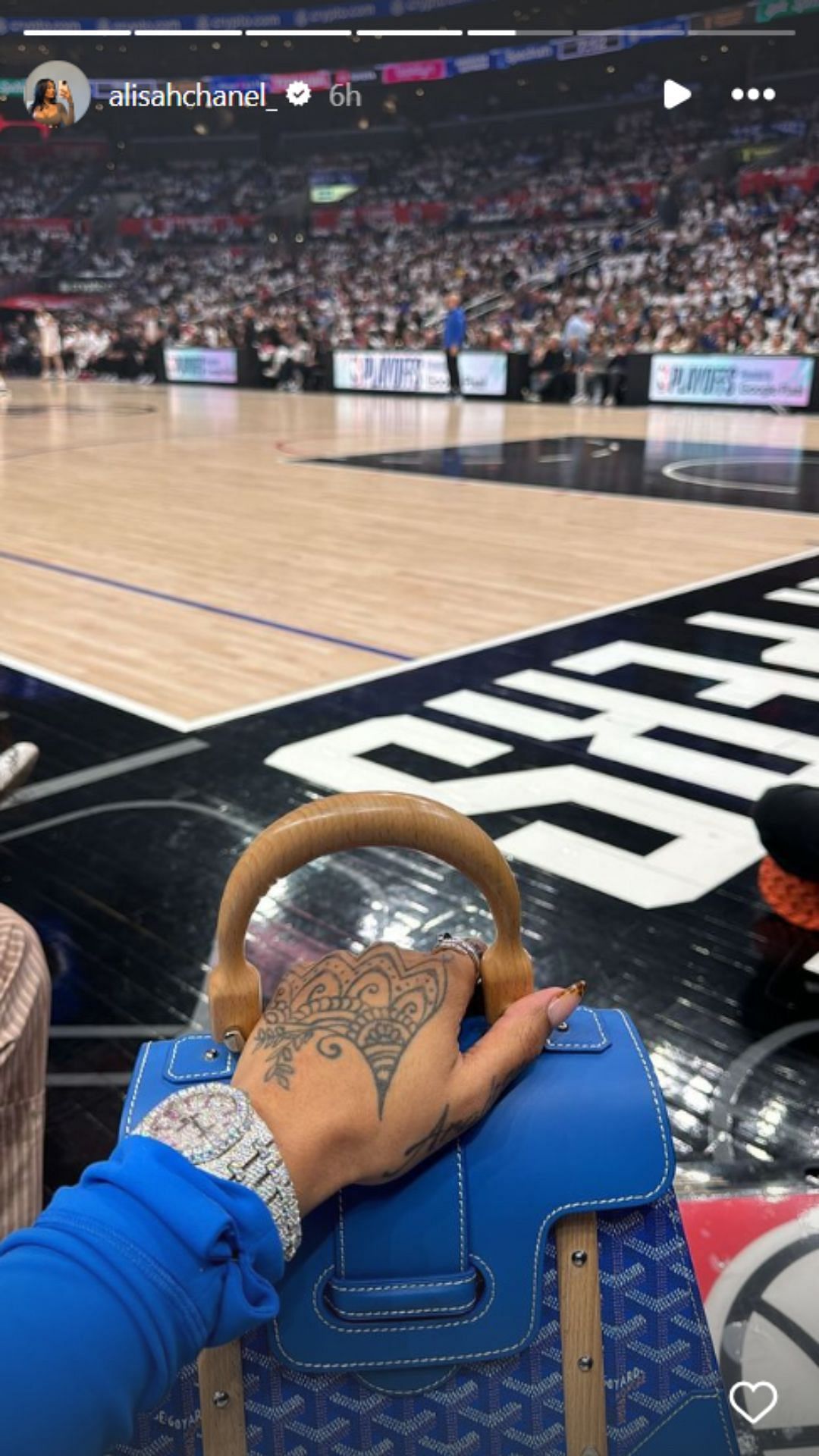 Alisah Chanel flaunts her Goyard bag with the Clippers home court in the background