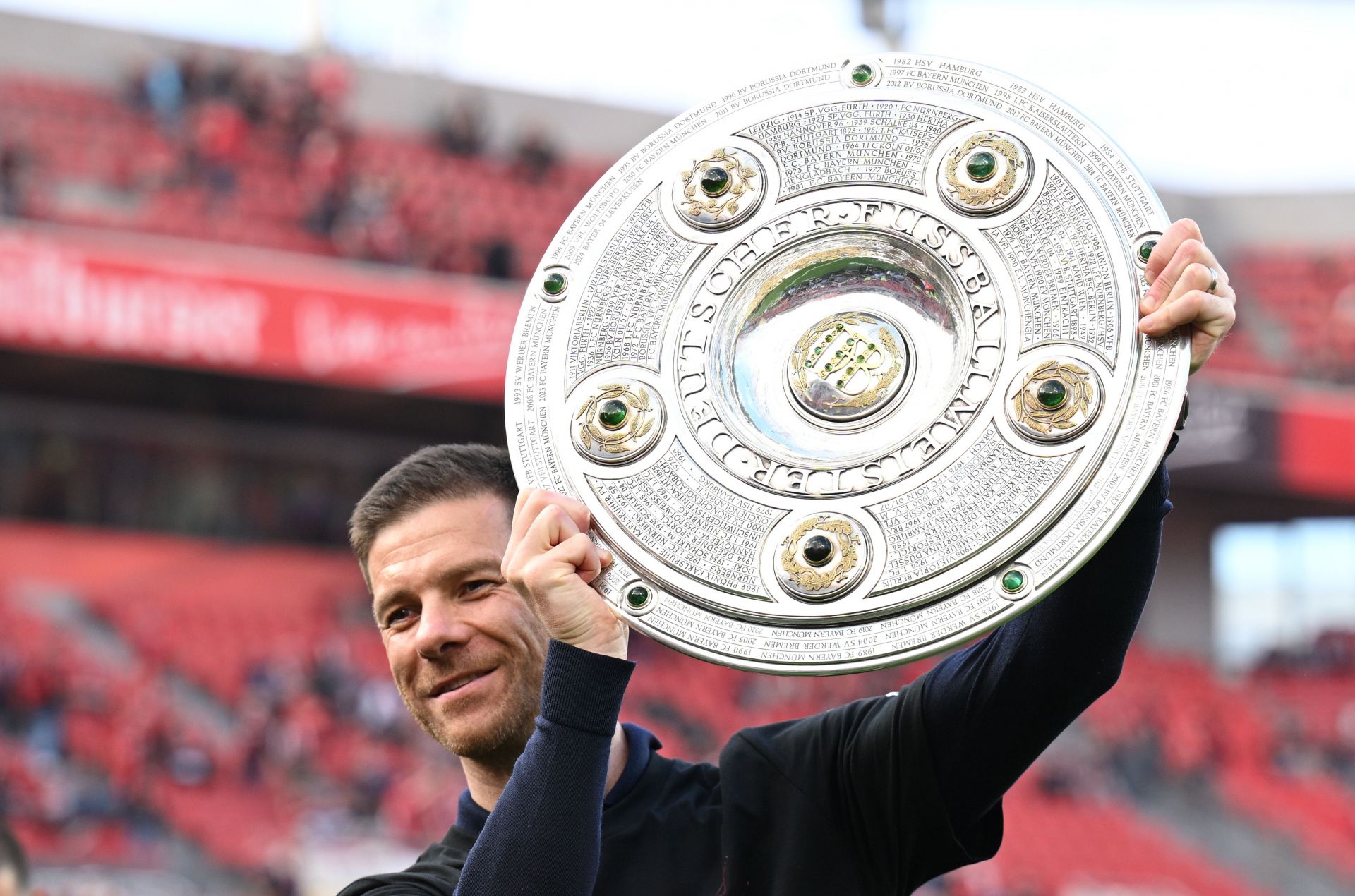 Xabi Alonso celebrates his first Bundesliga title as manager.