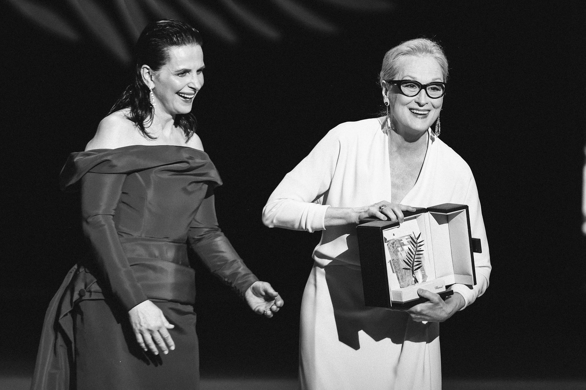 Meryl Streep (R) receives the Honorary Palme D&rsquo;Or Award from Juliette Binoche (L) on stage during the opening ceremony at the 77th annual Cannes Film Festival (Image via Getty)