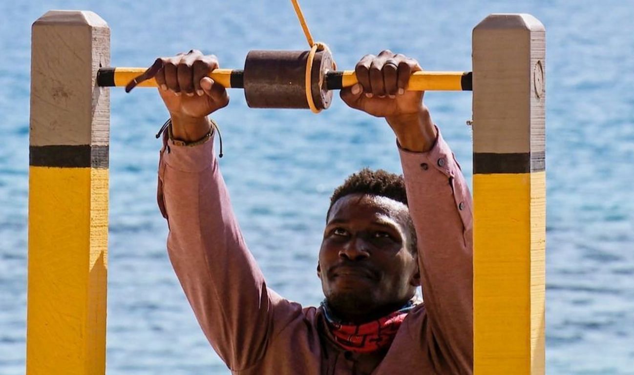 A still from the show of a contestant on the obstacle course