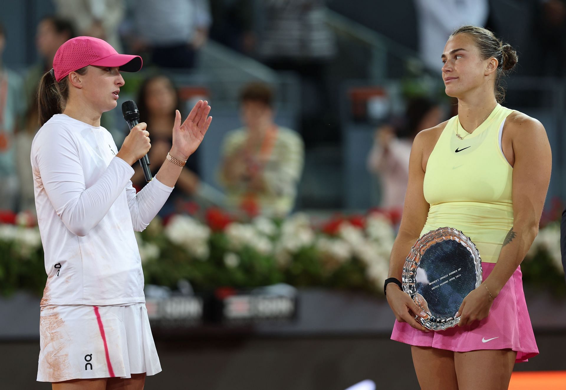 Iga Swiatek (L) and Aryna Sabalenka (R) during the 2024 Madrid Open women&#039;s singles trophy presentation ceremony