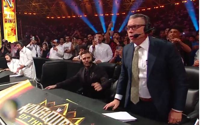 Current champion tries to get into a physical fight with Michael Cole; Corey Graves forced to interfere
