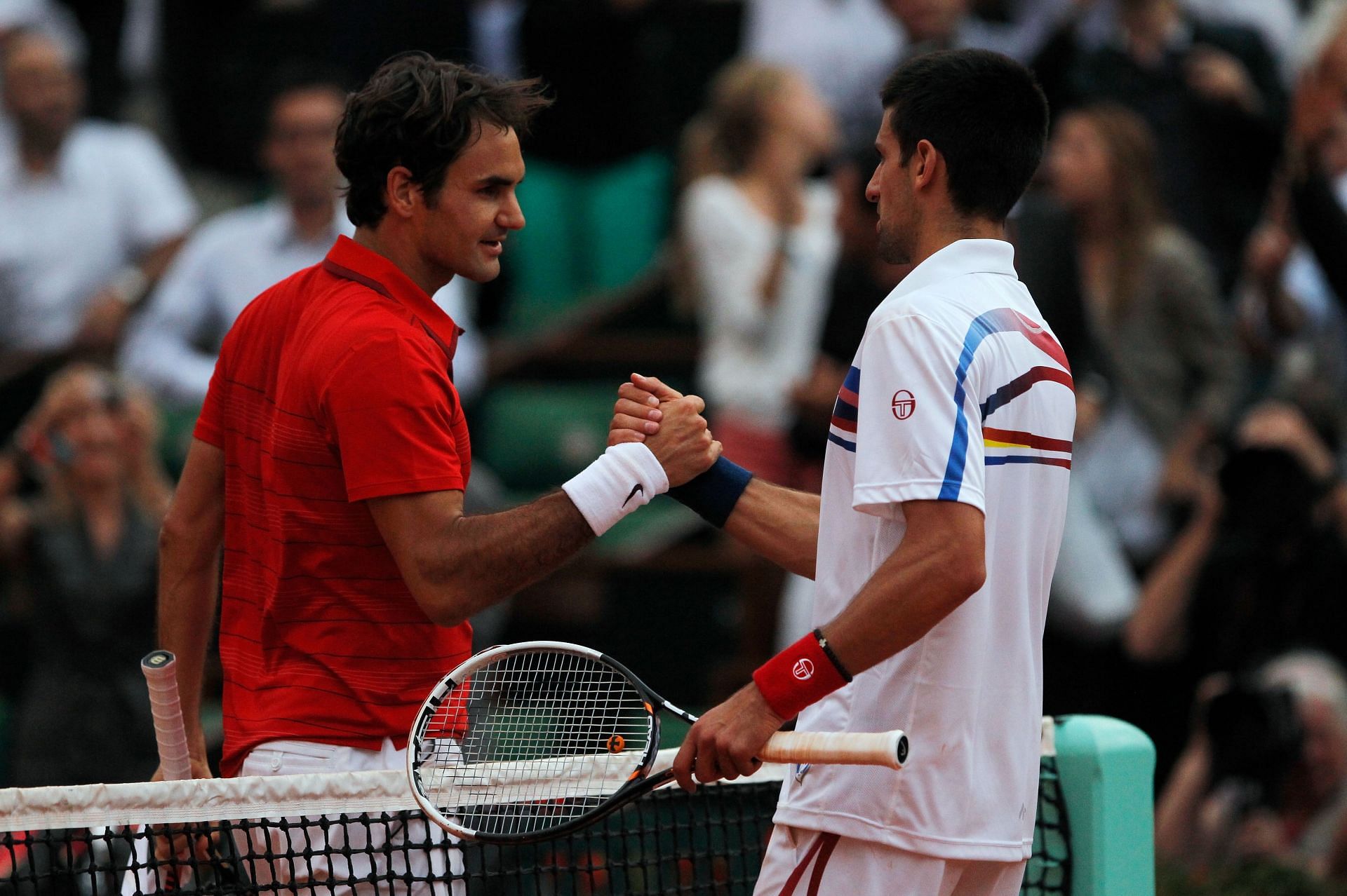 Novak Djokovic (right) and Roger Federer shake hands after French Open 2011 SF