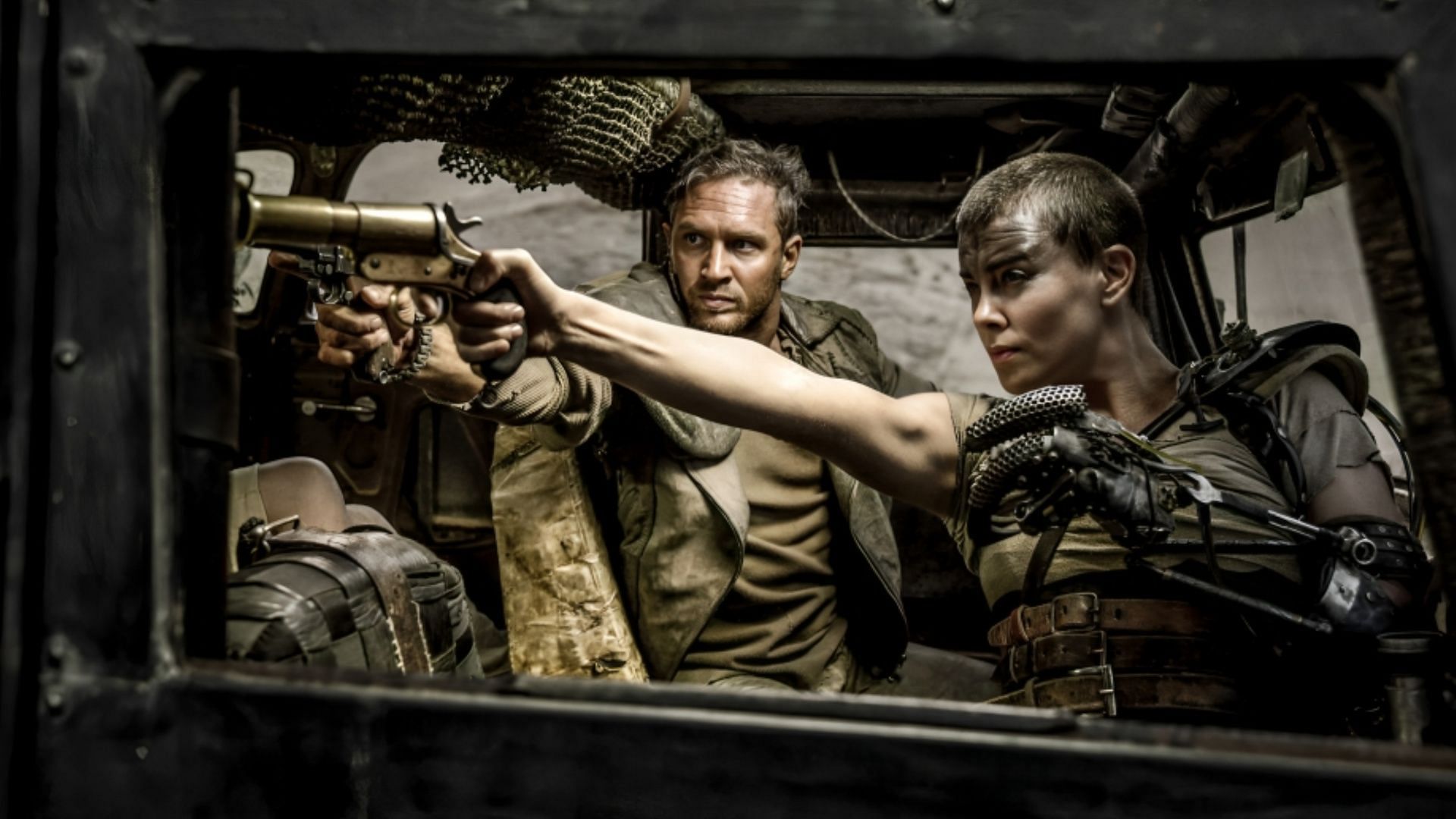 A scene from Mad Max: Fury Road featuring Tom Hardy and Charlize Theron (Image via Warner Bros)