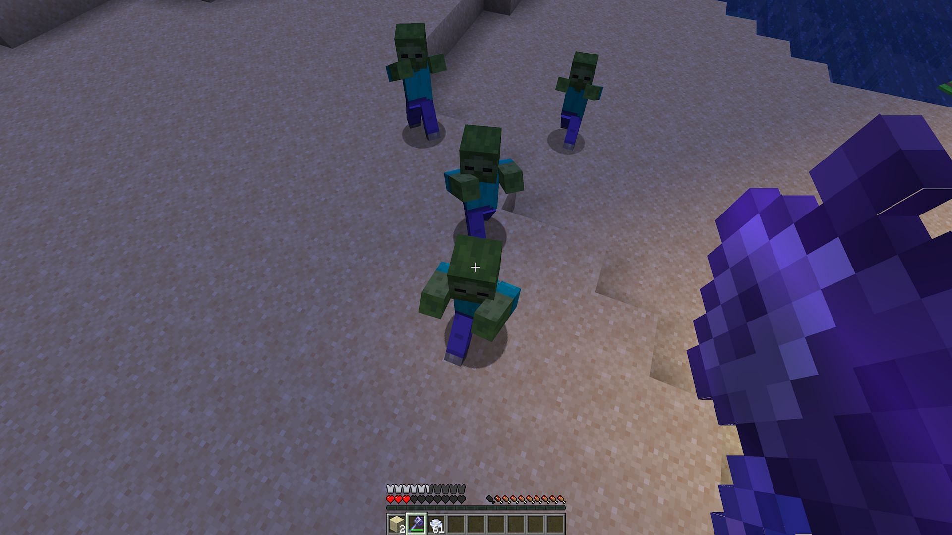 A player attacking zombies with an enchanted Minecraft mace (Image via Mojang)