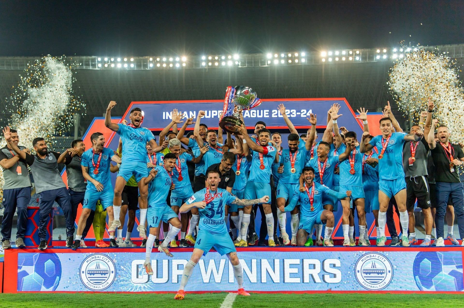 Mumbai City FC players celebrating with the ISL Cup.
