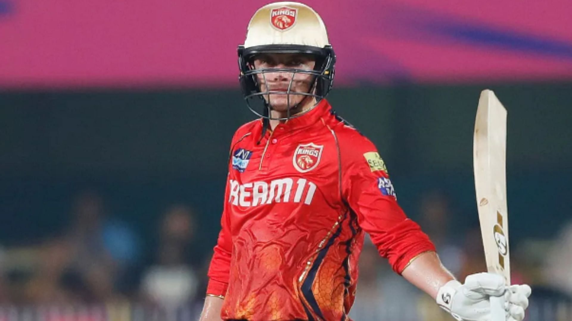 Sam Curran raises his bat after scoring a fifty against RR. 