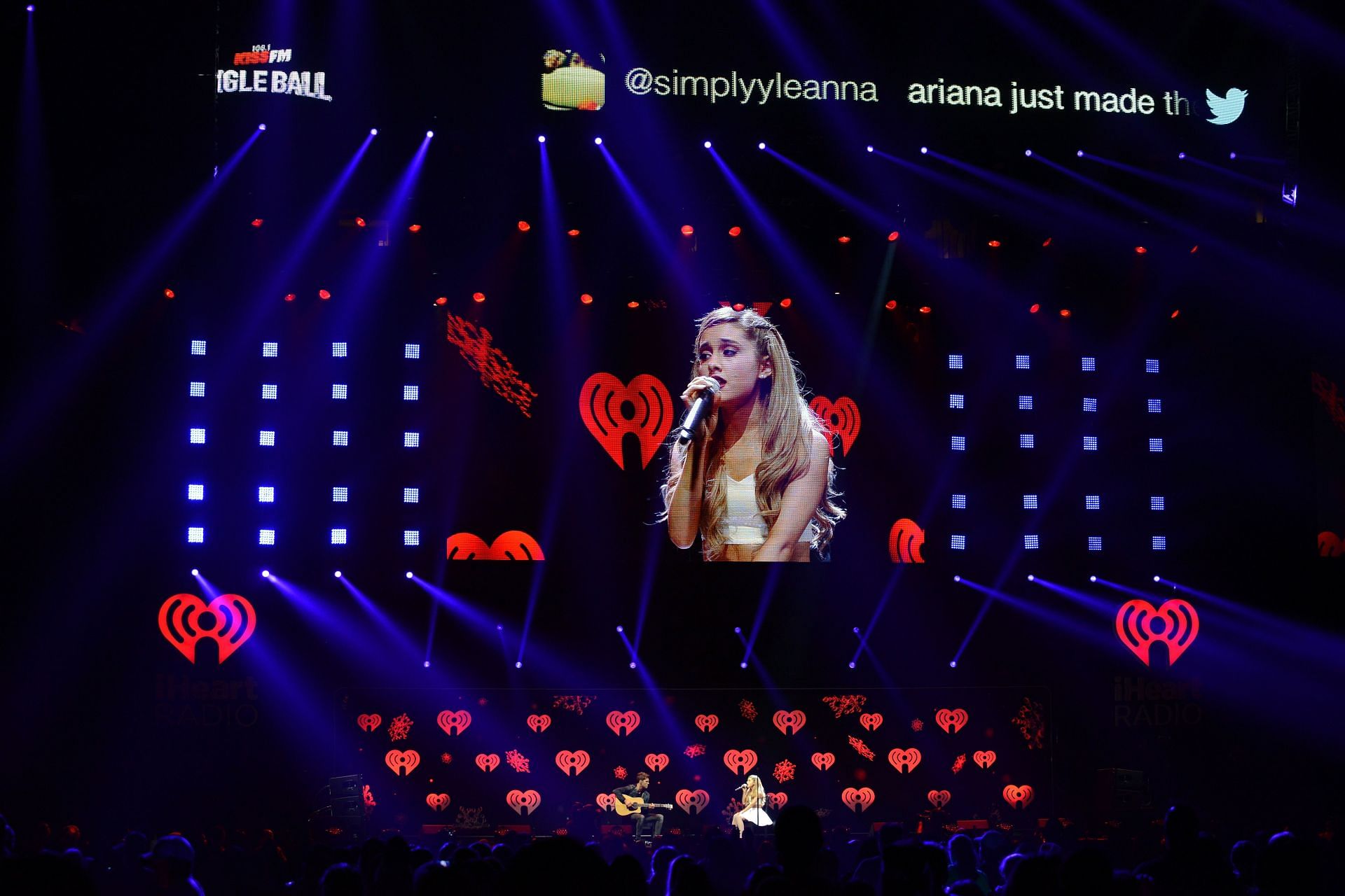 A still of Ariana singing on stage(Photo by Cooper Neill/Getty Images for Clear Channel)