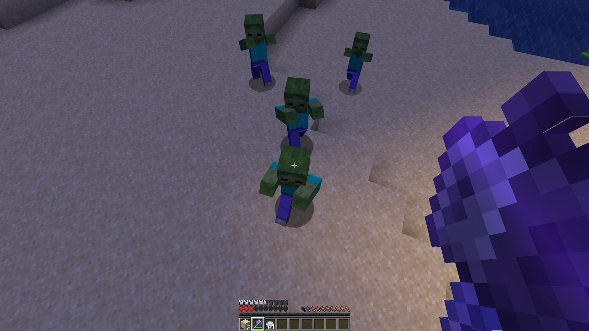 A player about to antagonize a group of zombies with a mace&#039;s smash attack (Image via Mojang)