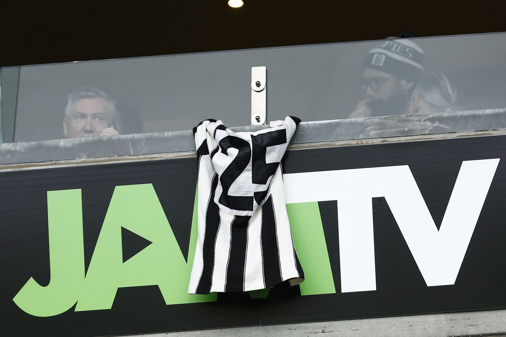 Former Collingwood president Eddie McGuire hangs a number 25 Collingwood jumper from the window of the media box paying tribute to former player Billy Picken on July 24, 2022