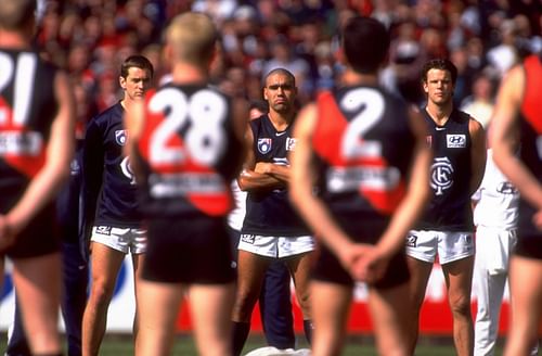 The Carlton Blues and Essendon Bombers players line up for the national anthem before the AFL second preliminary final of 1999