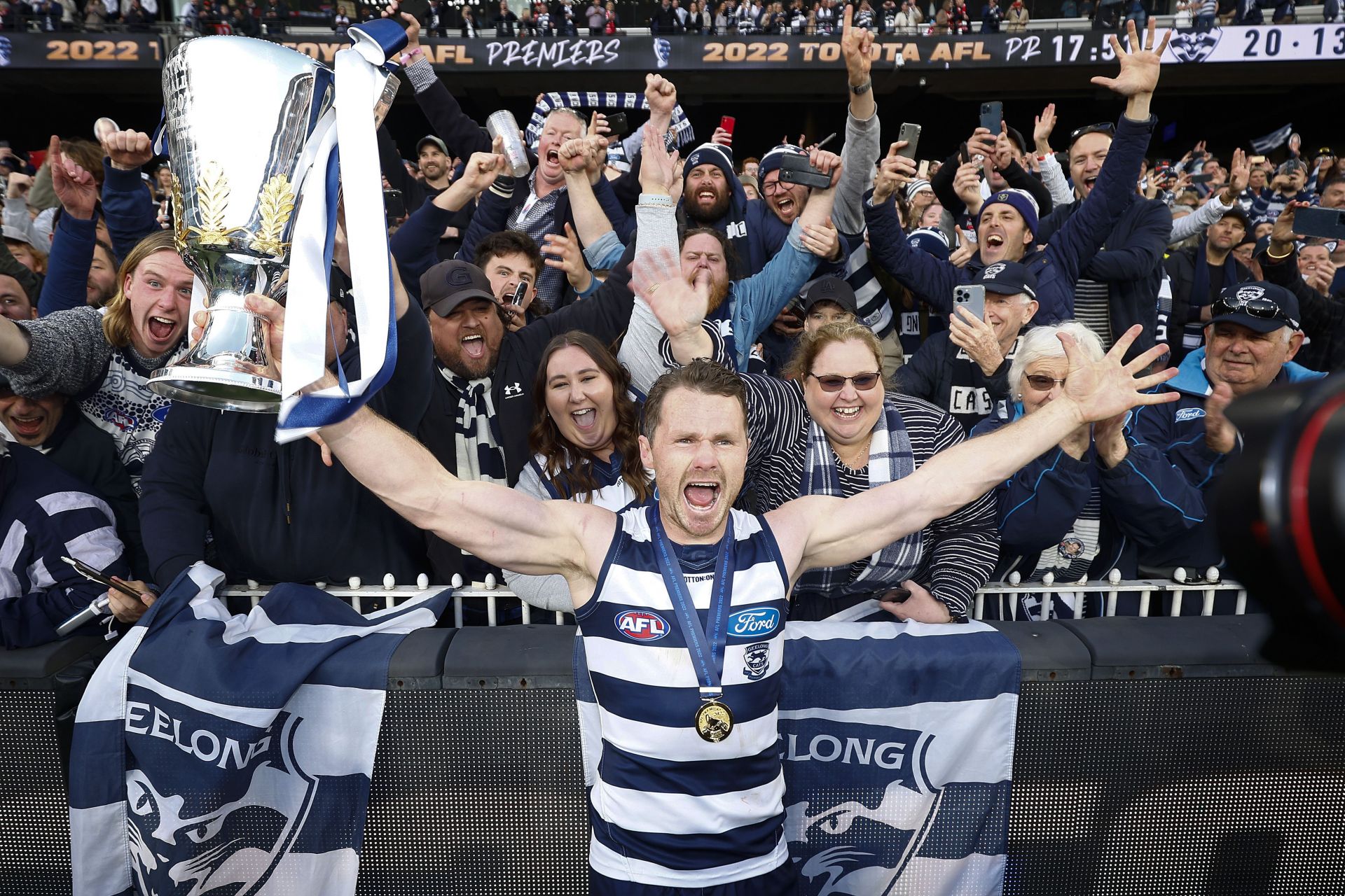 Patrick Dangerfield of the Cats holds the premiership cup as he celebrates