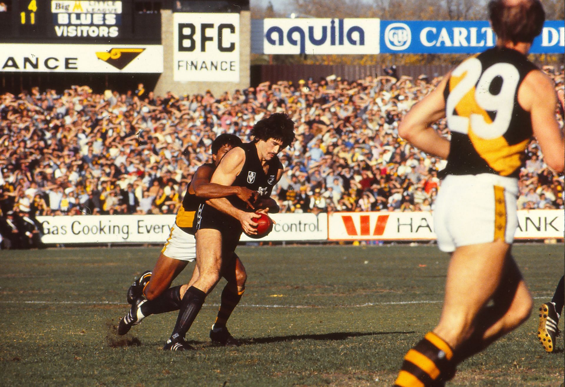 Mike Fitzpatrick of the Carlton Blues is tackled during a VFL match between Carlton Blues and Richmond Tigers