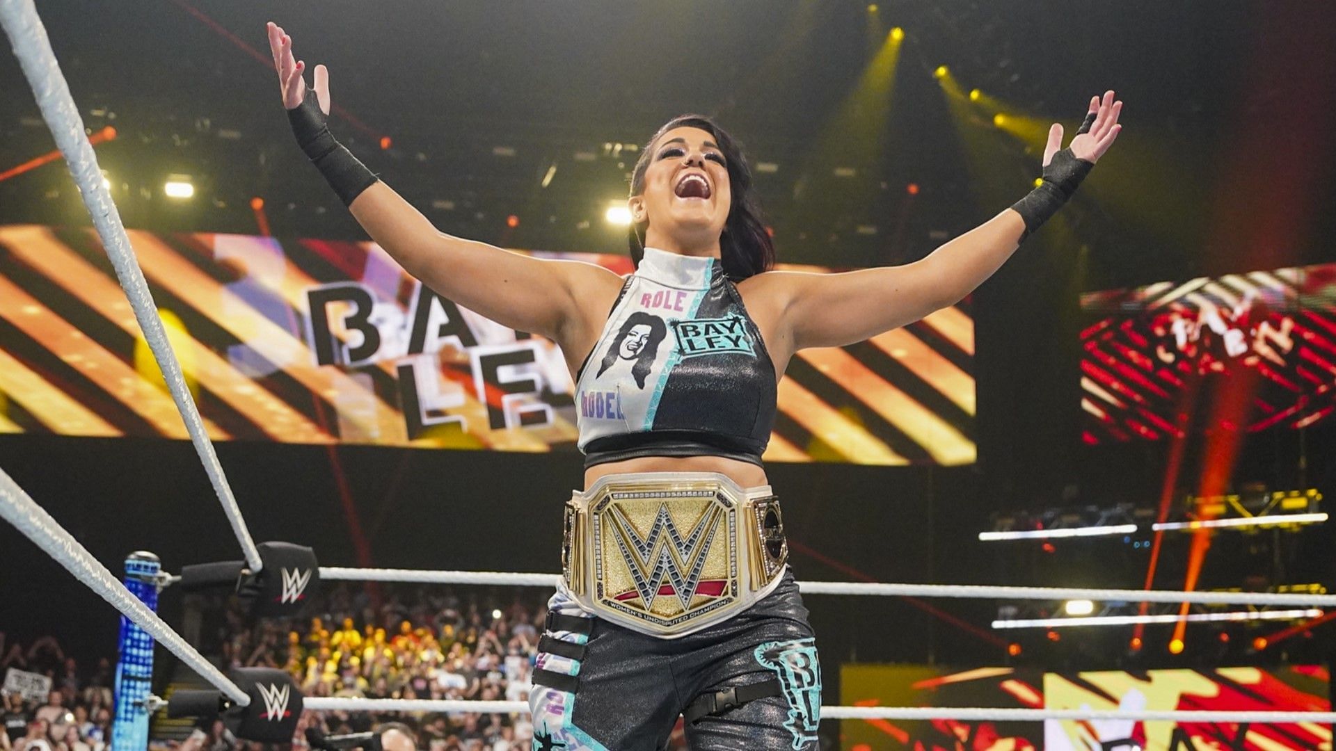 Bayley enters the ring with the WWE Women