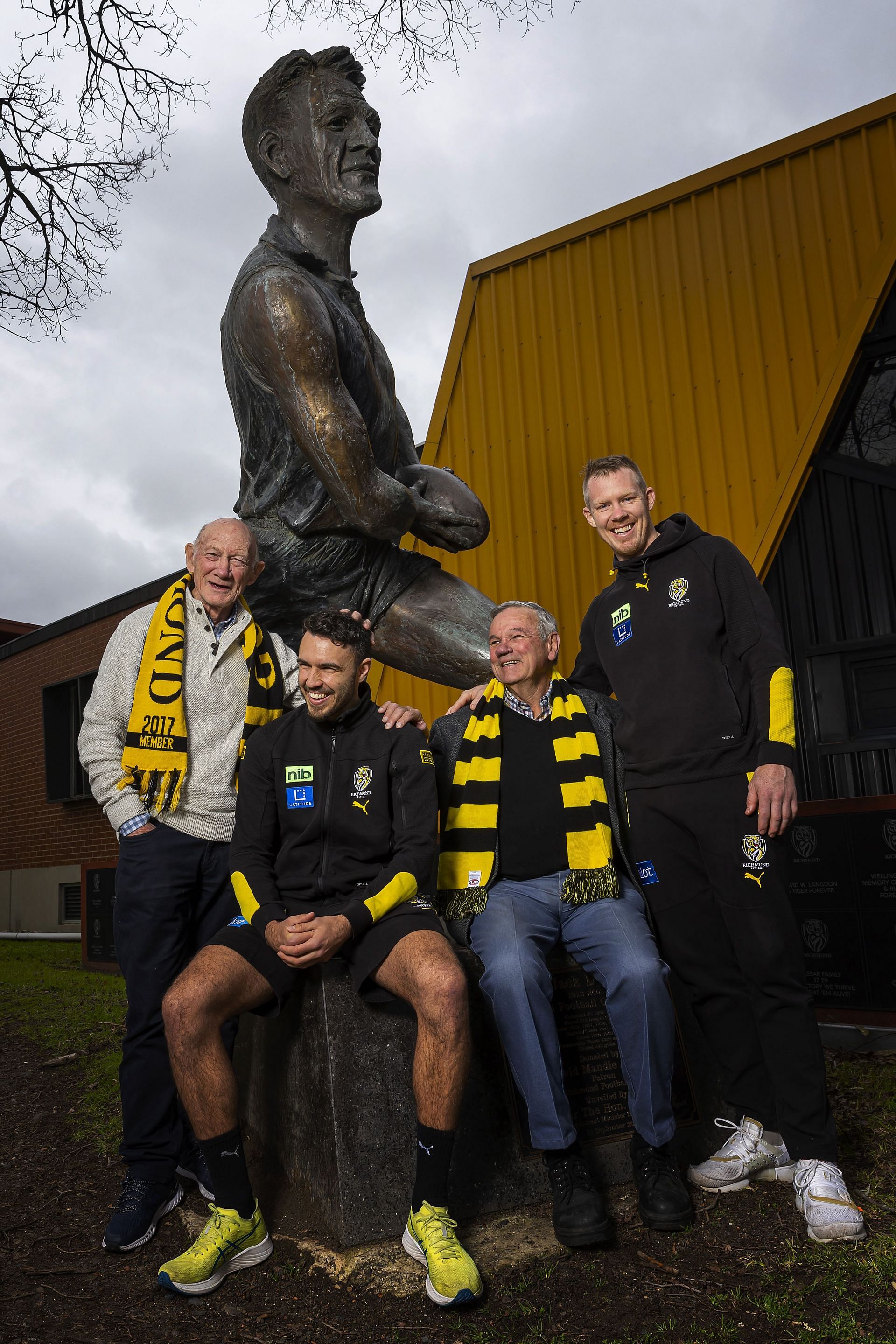 Tigers legend Kevin Bartlett, Shane Edwards of the Tigers, Tigers legend Francis Bourke and Jack Riewoldt of the Tigers pose for a photograph under the Jack Dyer statue