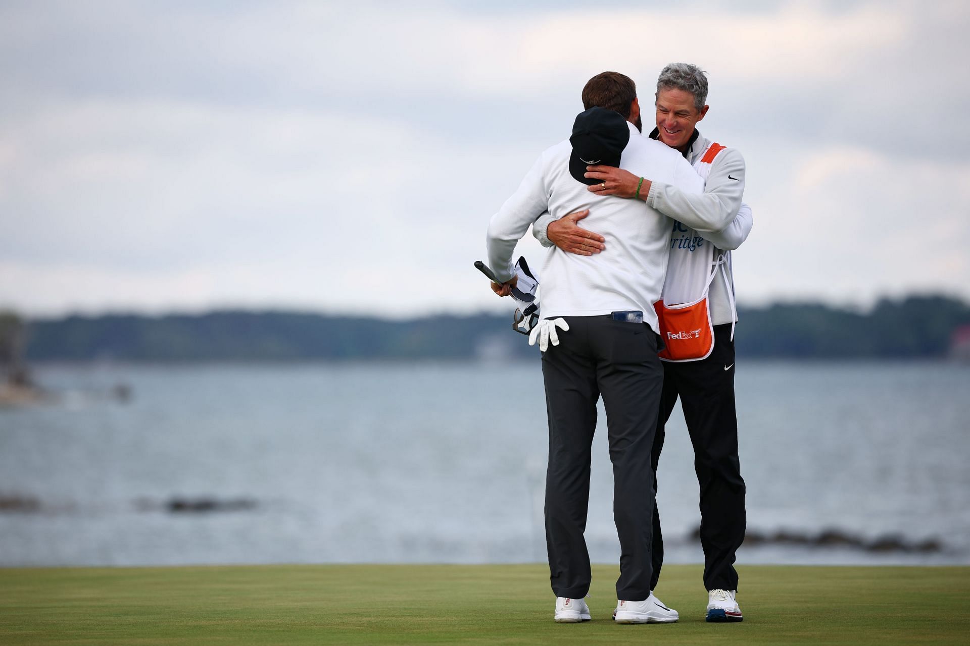 Scottie Scheffler celebrating his win at RBC Heritage with his caddie, Ted Scott