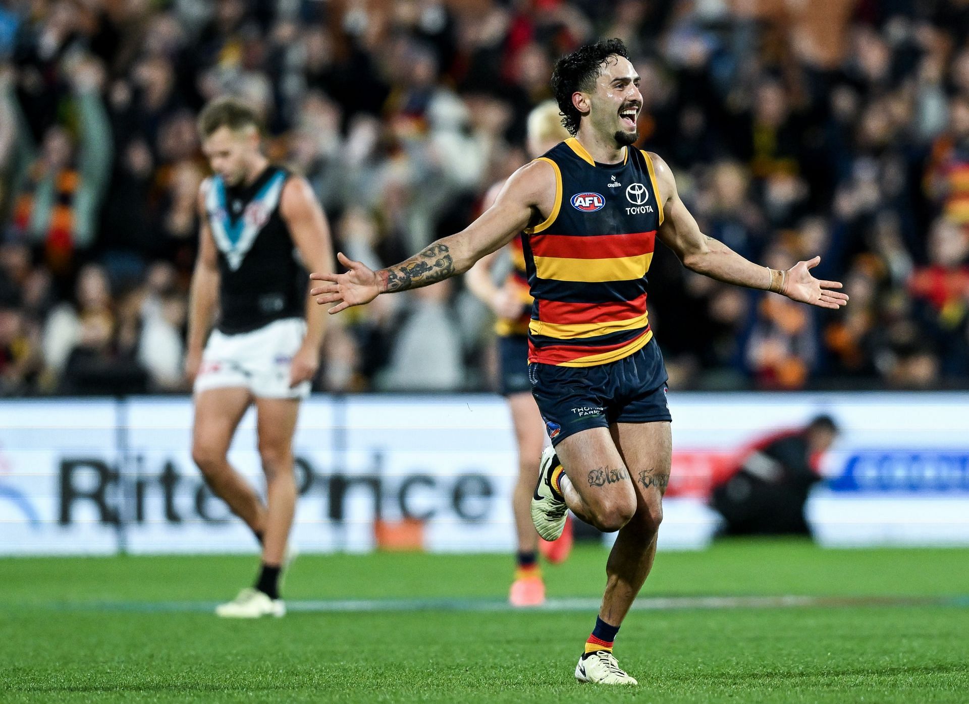 Izak Rankine of the Crows celebrates scoring against Port Adelaide